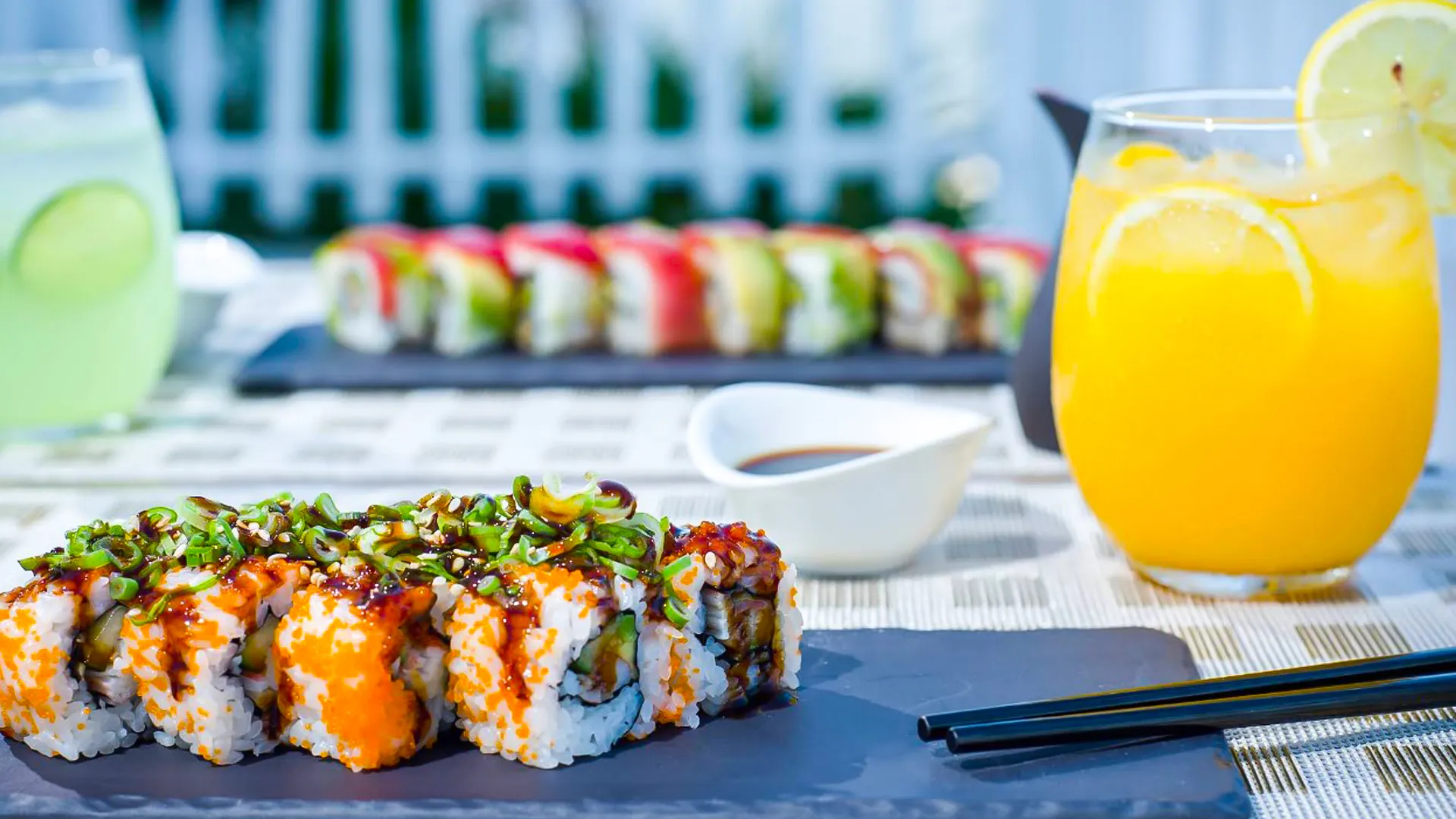 Colorful sushi rolls and fresh orange juice served at Oleo Cancun Playa restaurant.