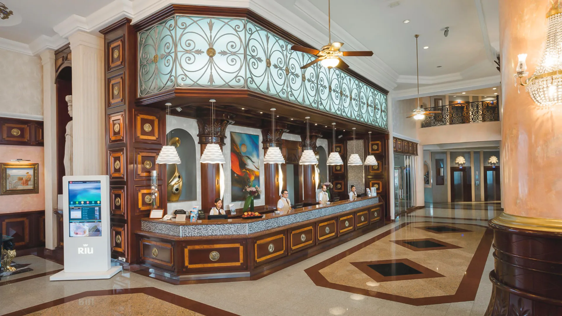 Luxurious lobby and reception area with chandeliers and marble floors at Riu Palace Las Americas Cancun.