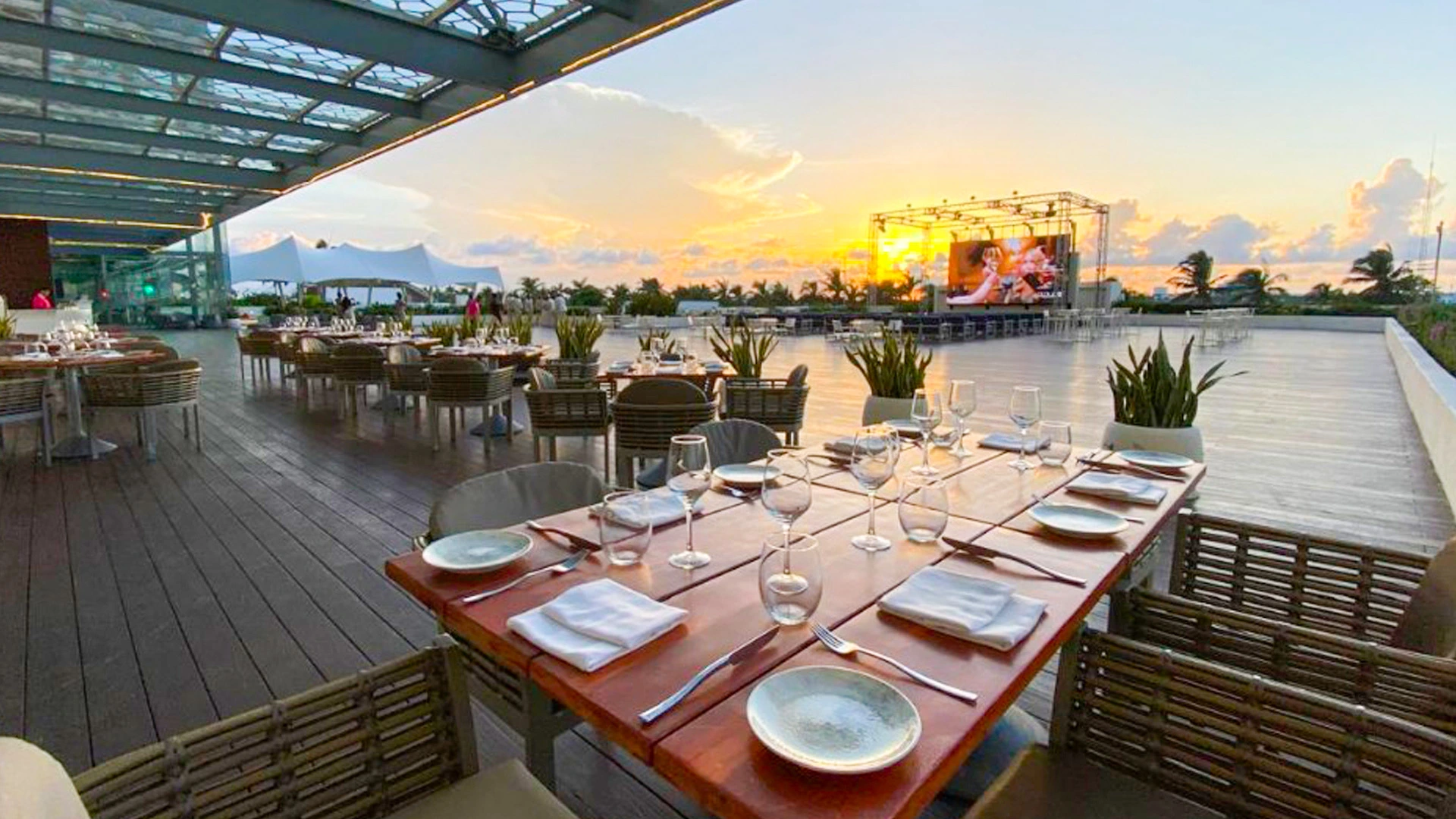 Sunset dining terrace at Royalton Chic Cancun with elegant table setup and panoramic views of the Caribbean Sea.