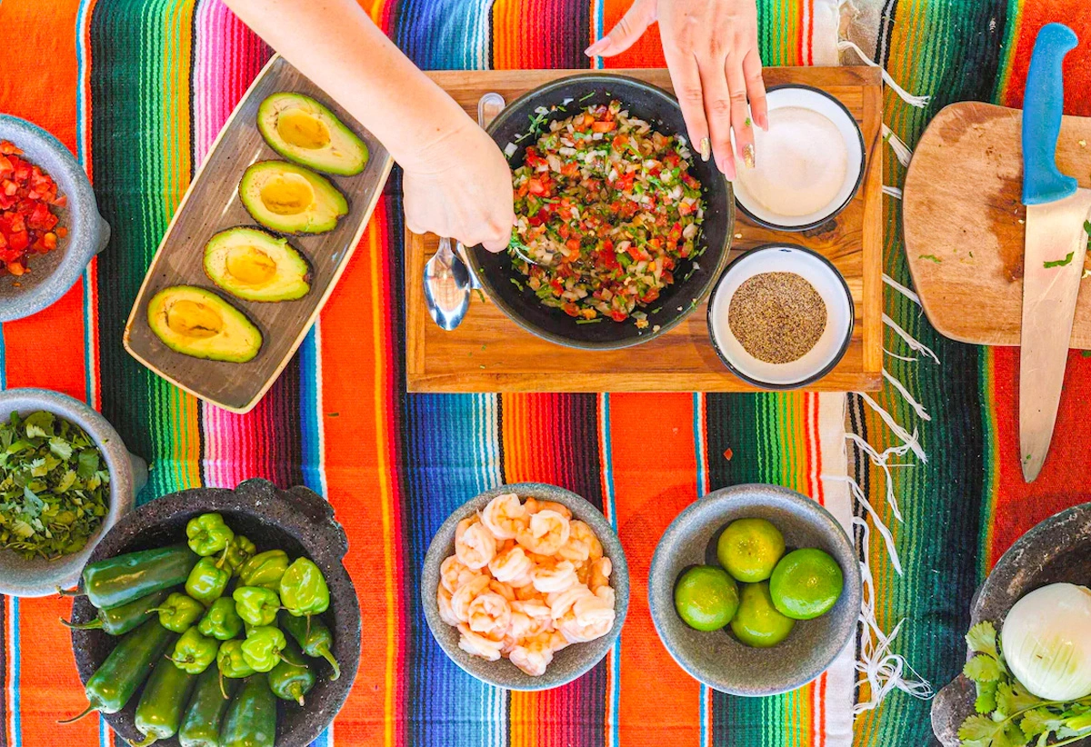 Traditional Mexican guacamole cooking class at The Westin Cancun with fresh ingredients and colorful setup.