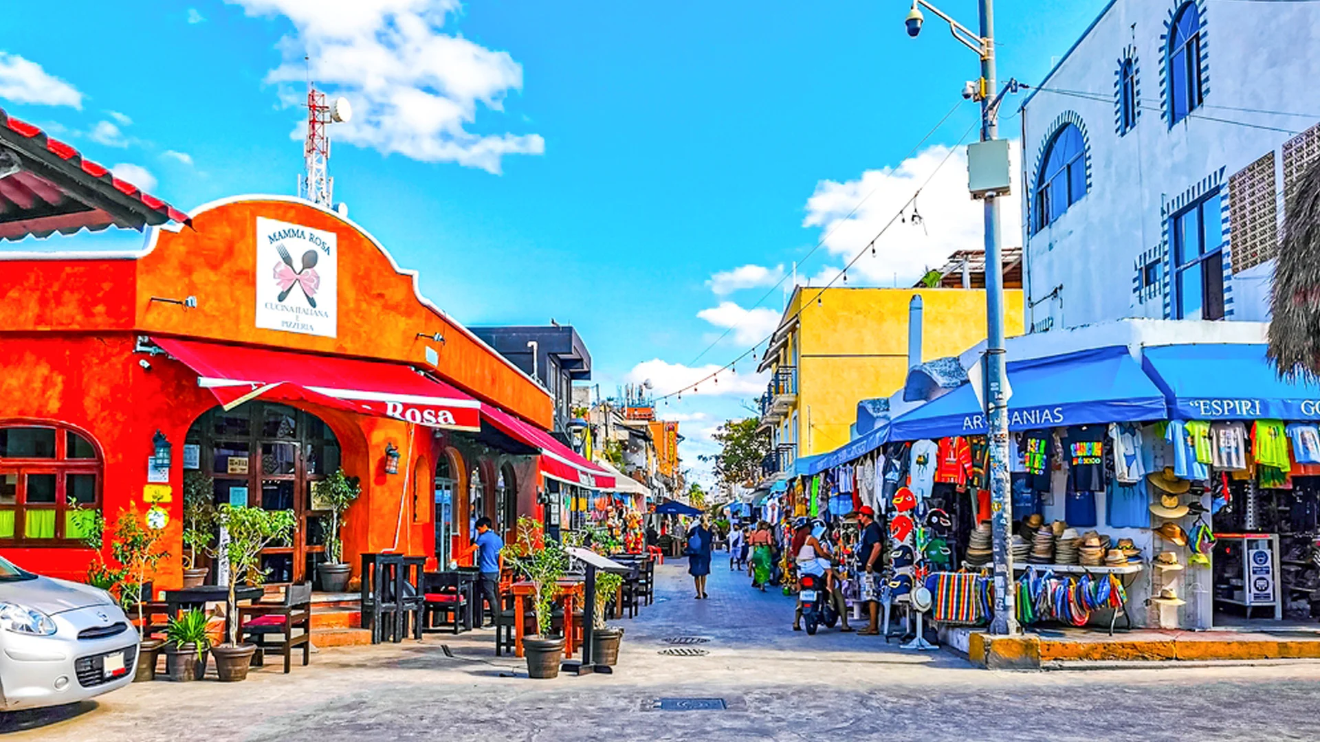 Colorful local market street near Cancun with restaurants, souvenir shops, and crafts.