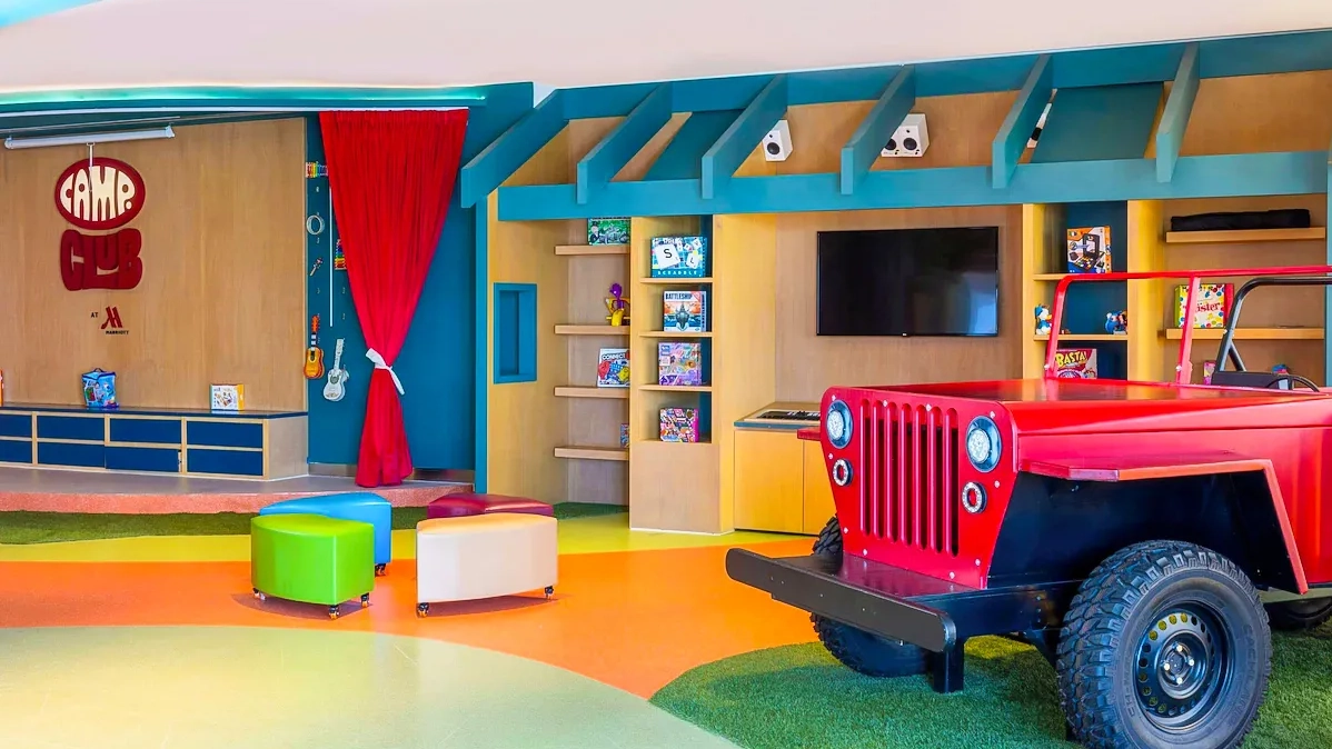 Colorful Camp Club kids area at Marriott Cancun Resort with play zone, mini Jeep, and creative decor.