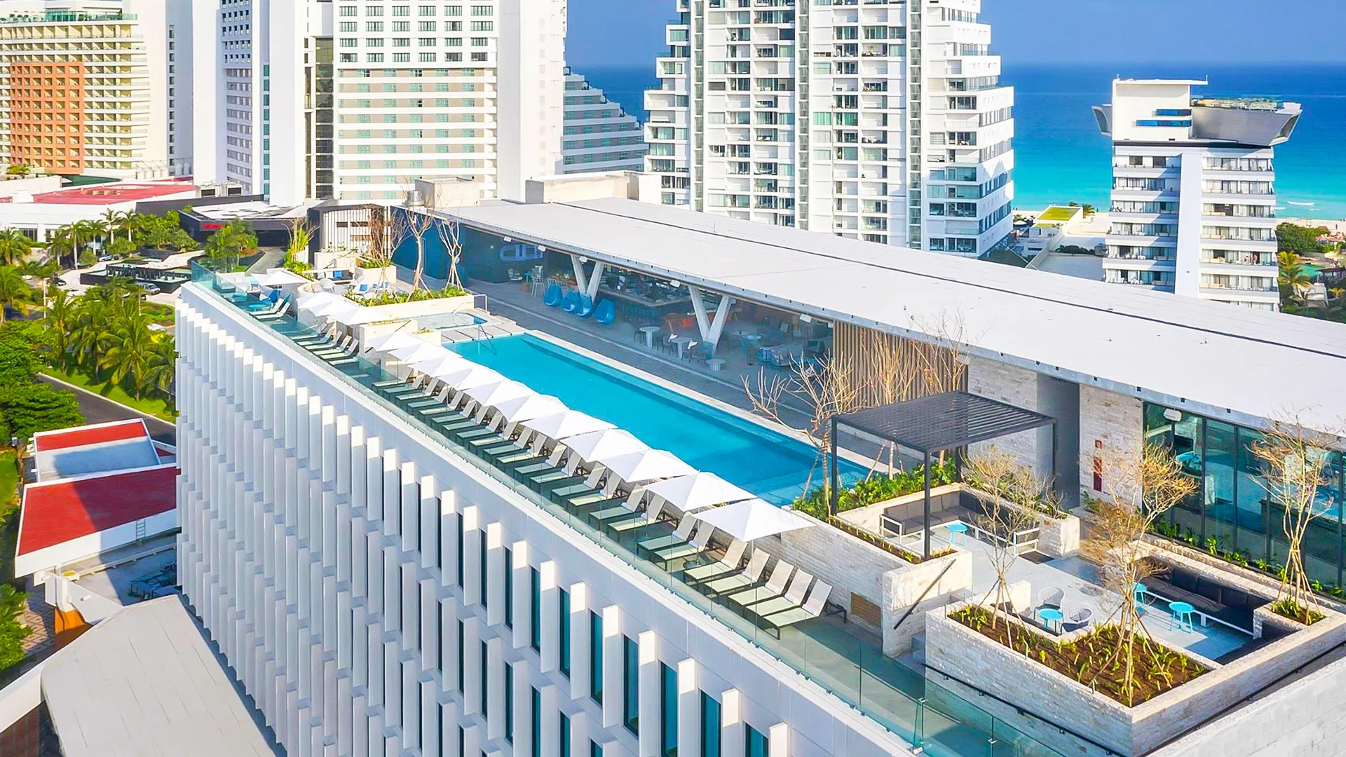 Rooftop infinity pool at Hilton Cancun overlooking the hotel zone and the Caribbean Sea.