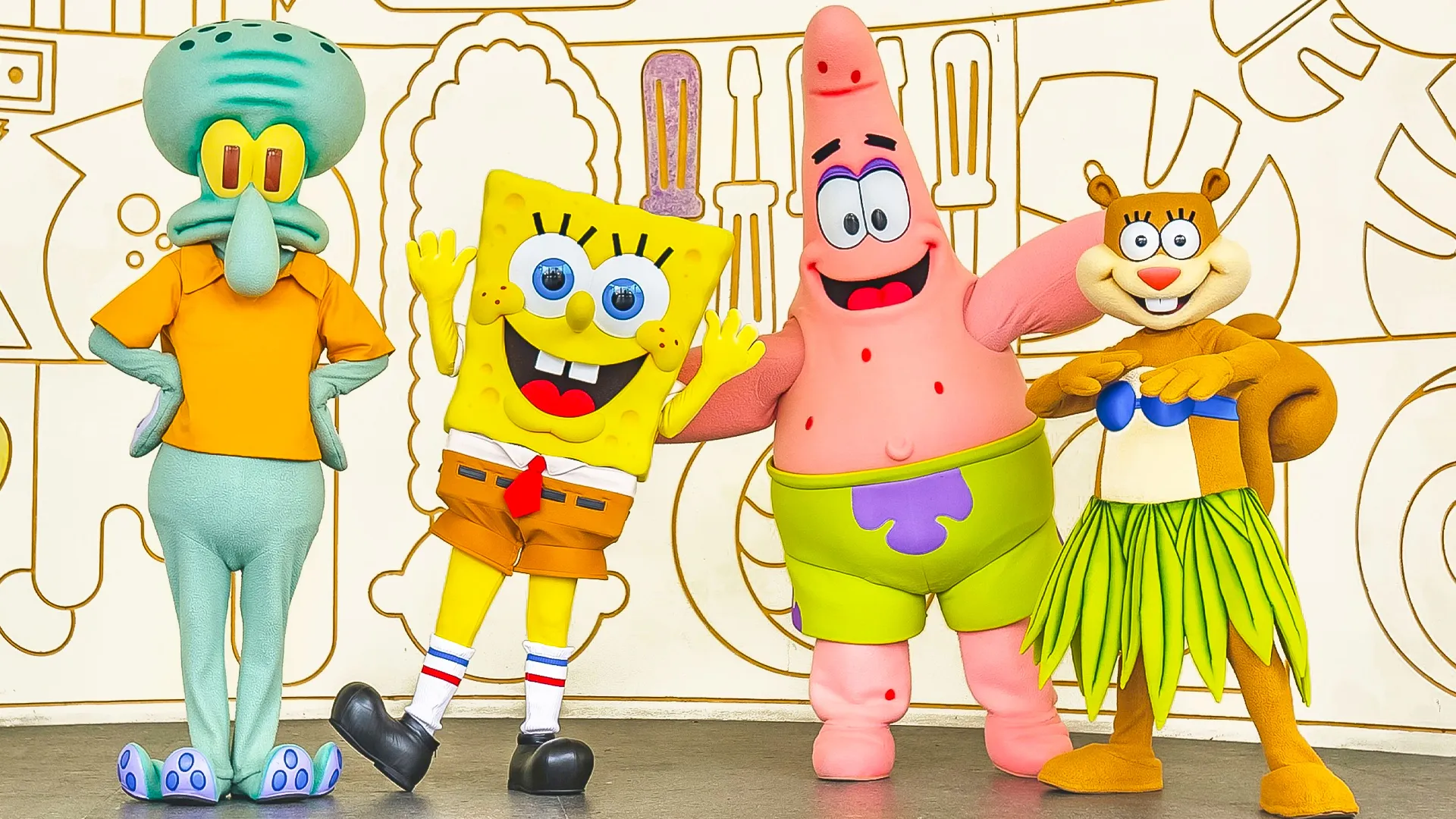SpongeBob SquarePants, Patrick Star, Squidward, and Sandy Cheeks posing together for photos at Nickelodeon Resort Cancun. 