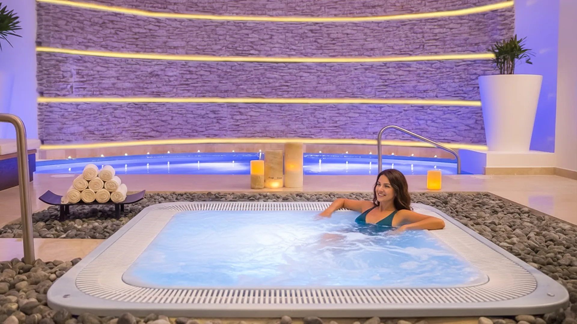 Woman enjoying hydrotherapy circuit at Le Blanc Cancun’s Blanc Spa, relaxing in a therapeutic setting.