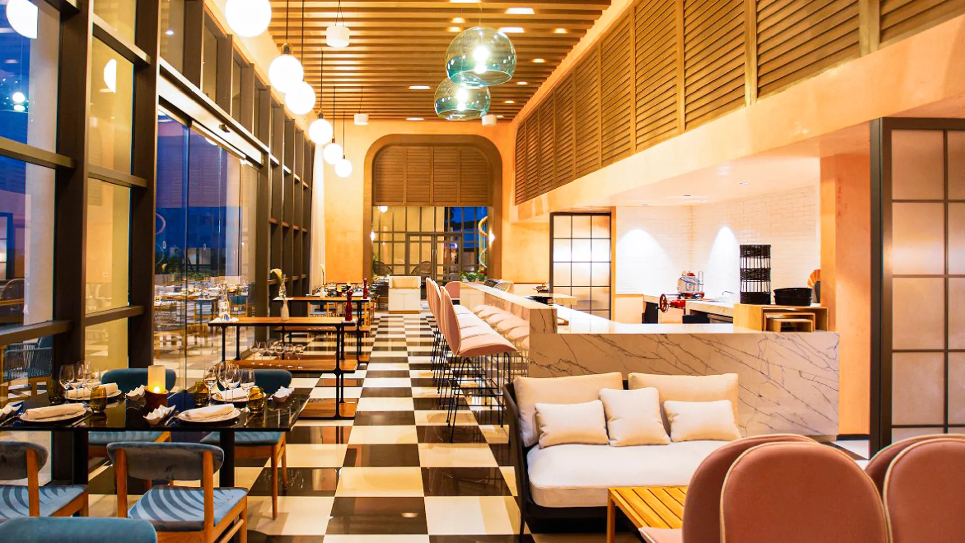 The interior of a stylish and modern restaurant at Atelier Hotel, with sleek furniture and sophisticated lighting.