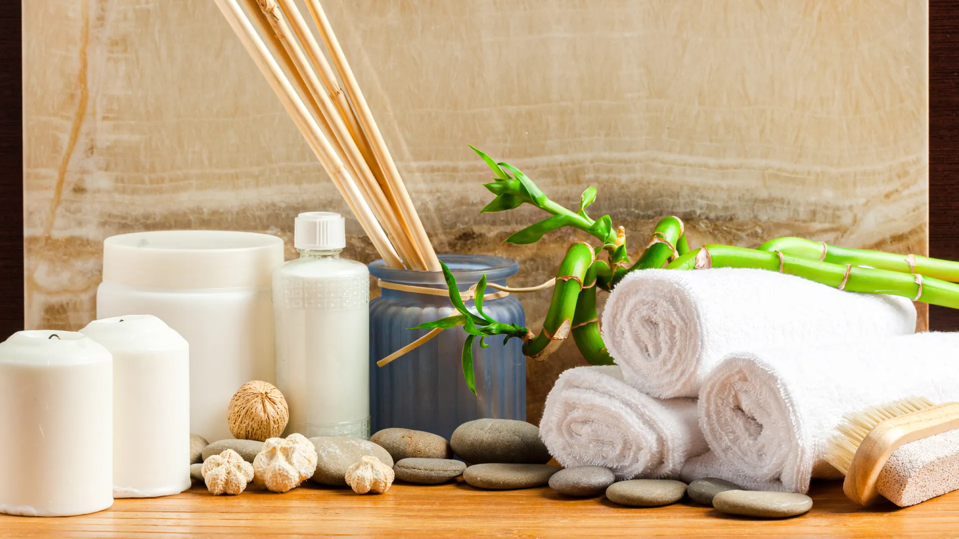 A serene spa setting with candles, rocks, and bamboo, creating a peaceful atmosphere at NUUP Spa in Atelier Hotel.