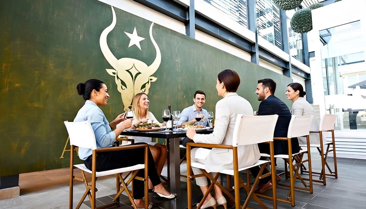 Group of friends dining together at Royalton Riviera Cancun’s stylish outdoor restaurant.