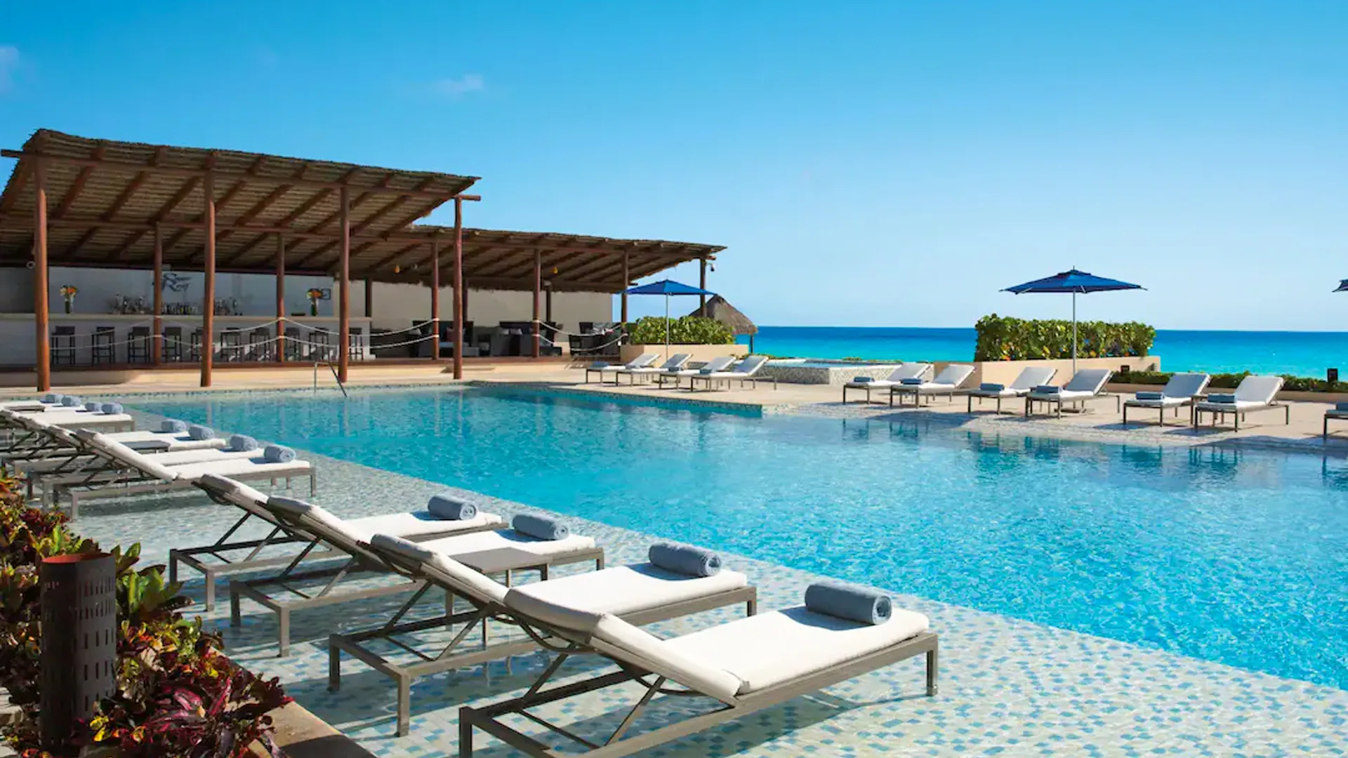 What is the main difference between Secrets The Vine and Secrets Playa Mujeres?