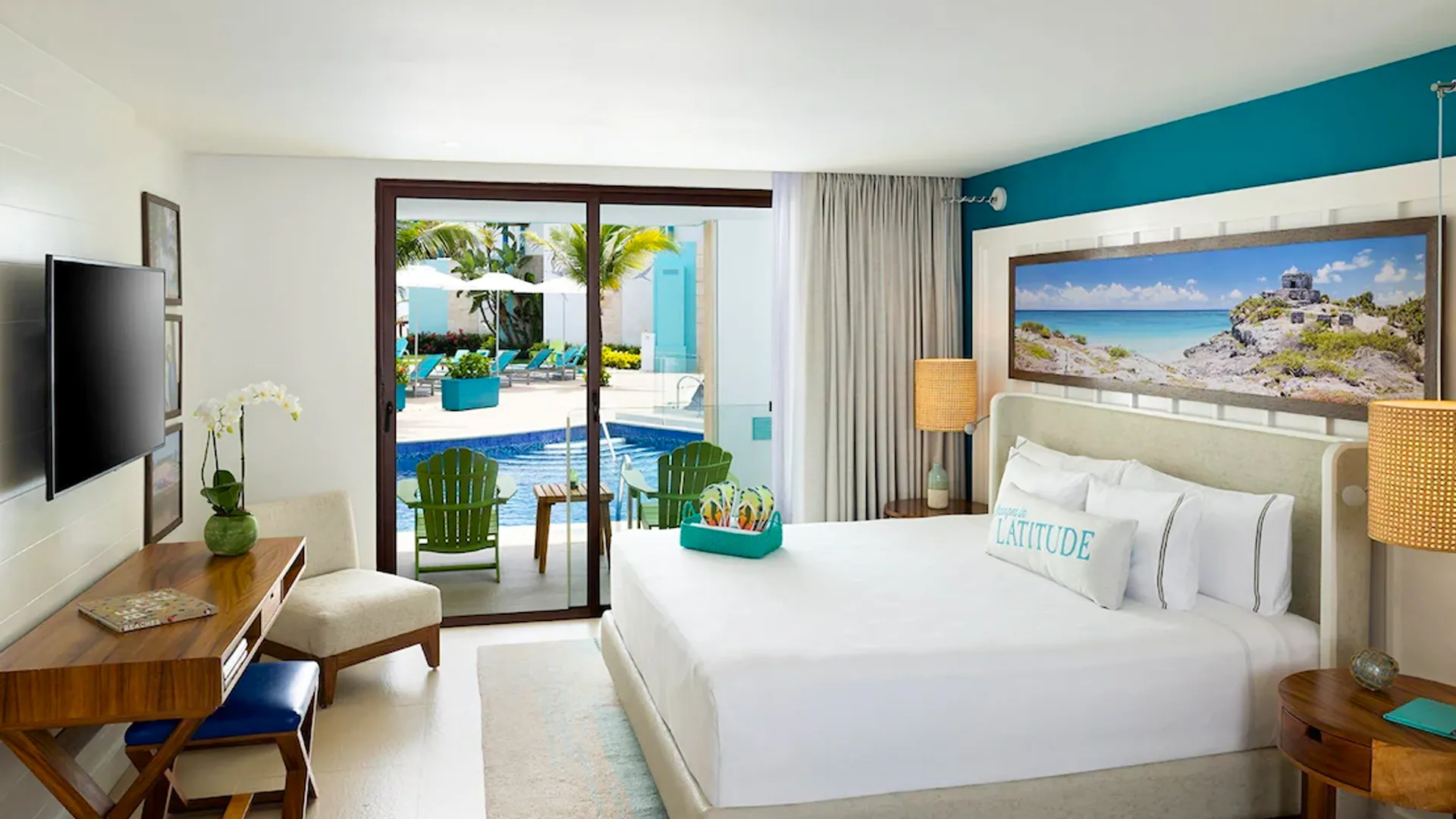 Modern beach-themed hotel room at Margaritaville Cancun with white linens, turquoise decor, and a terrace leading to a swim-up pool.