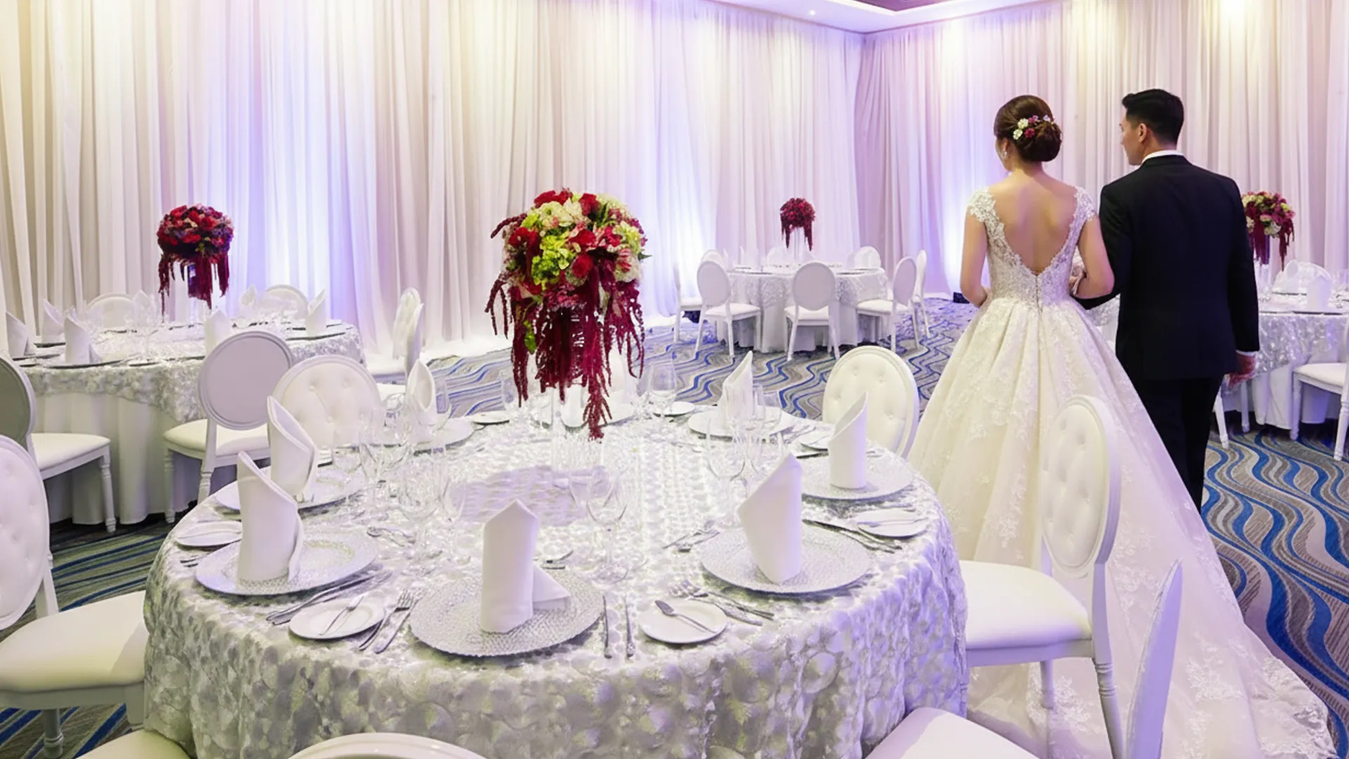 Bride and groom walking into an elegant indoor wedding reception hall at Royalton Riviera Cancun.