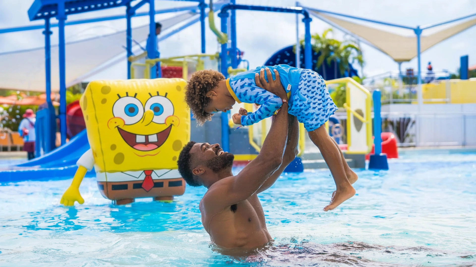Father and child enjoying the water park with SpongeBob at Nickelodeon Riviera Maya.