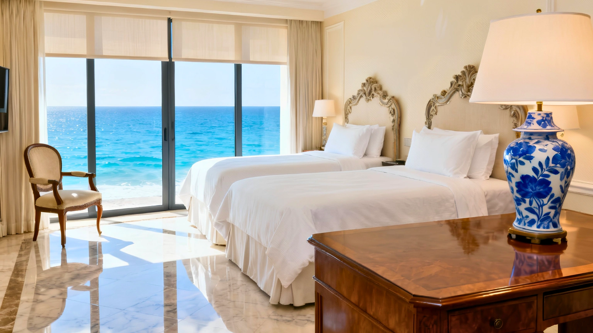  Luxurious Sandos Cancun room with king bed, ornate headboard, and floor-to-ceiling ocean view.