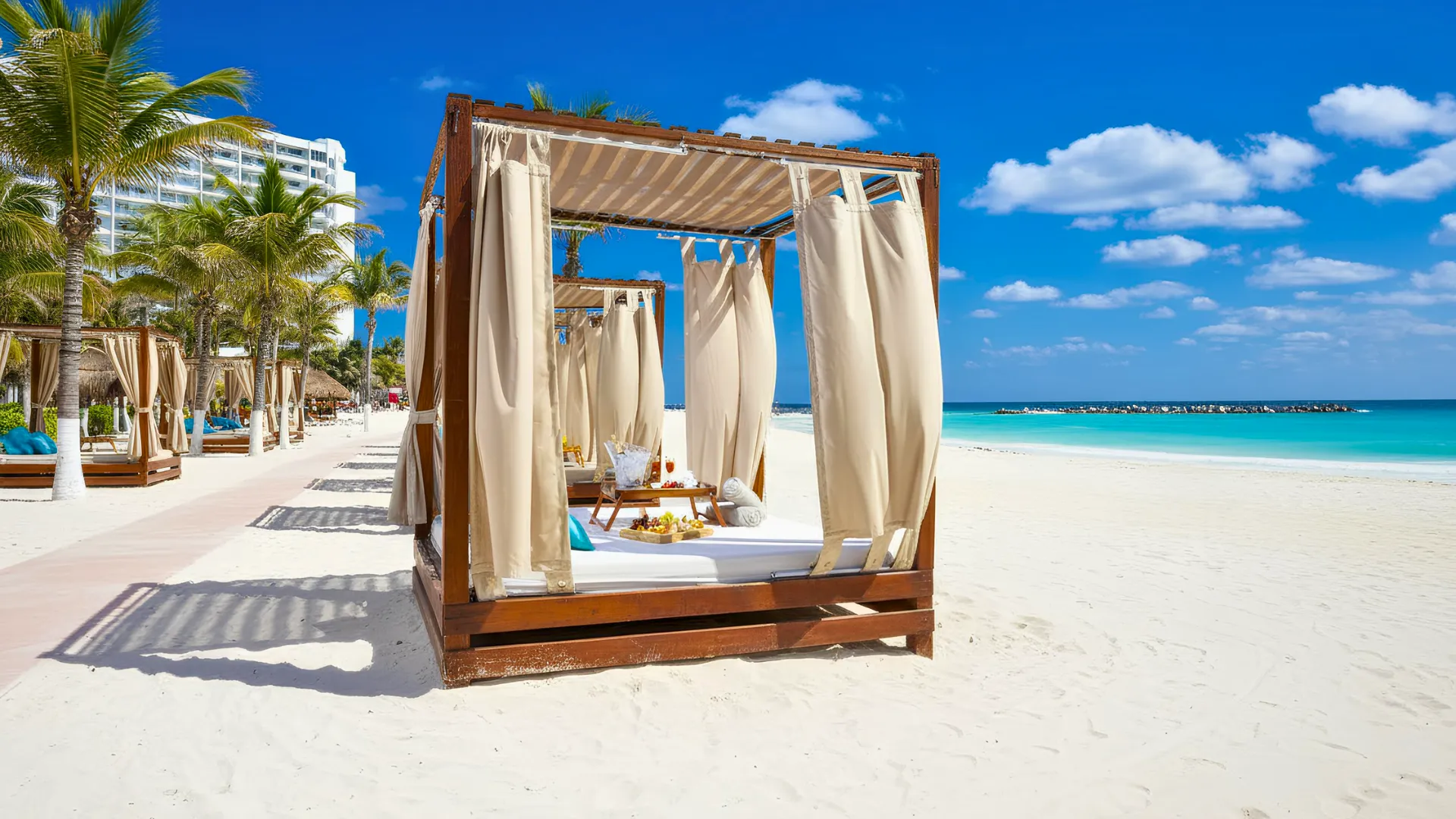 Krystal Cancun beach with beach beds and clear blue waters.