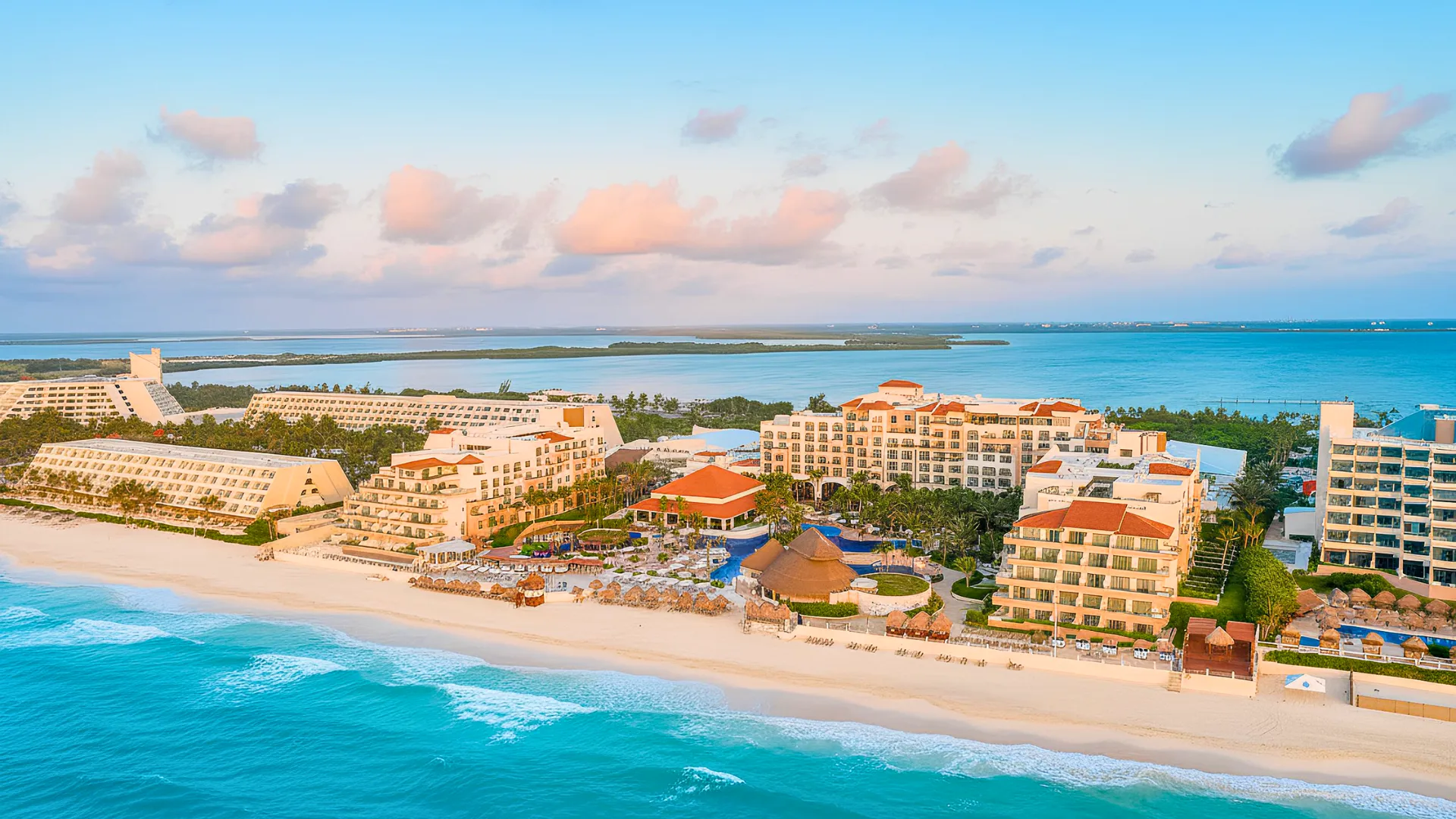 Aerial view of Fiesta Americana Cancun resort overlooking turquoise Caribbean waters and white sandy beach.