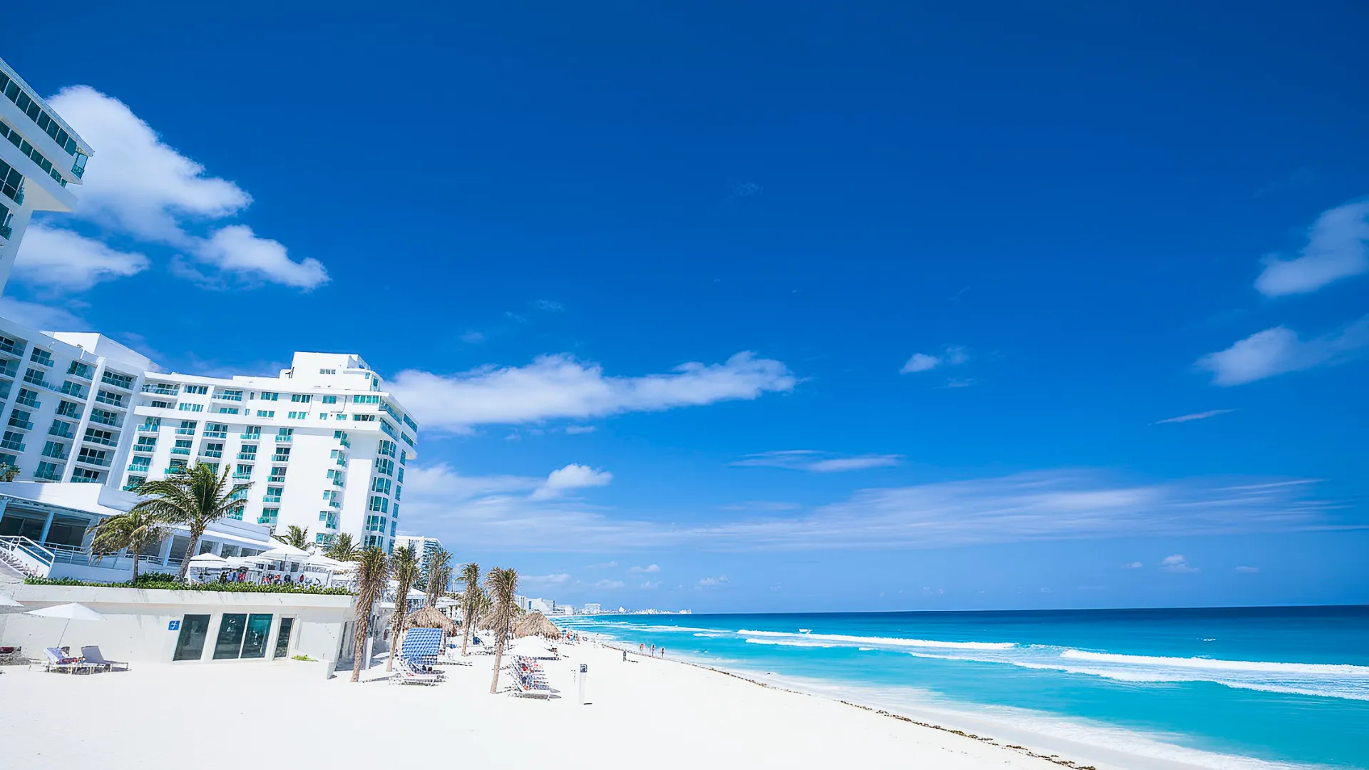 A pristine beach view with the Óleo Cancun resort in the background, offering a perfect blend of relaxation and luxury.