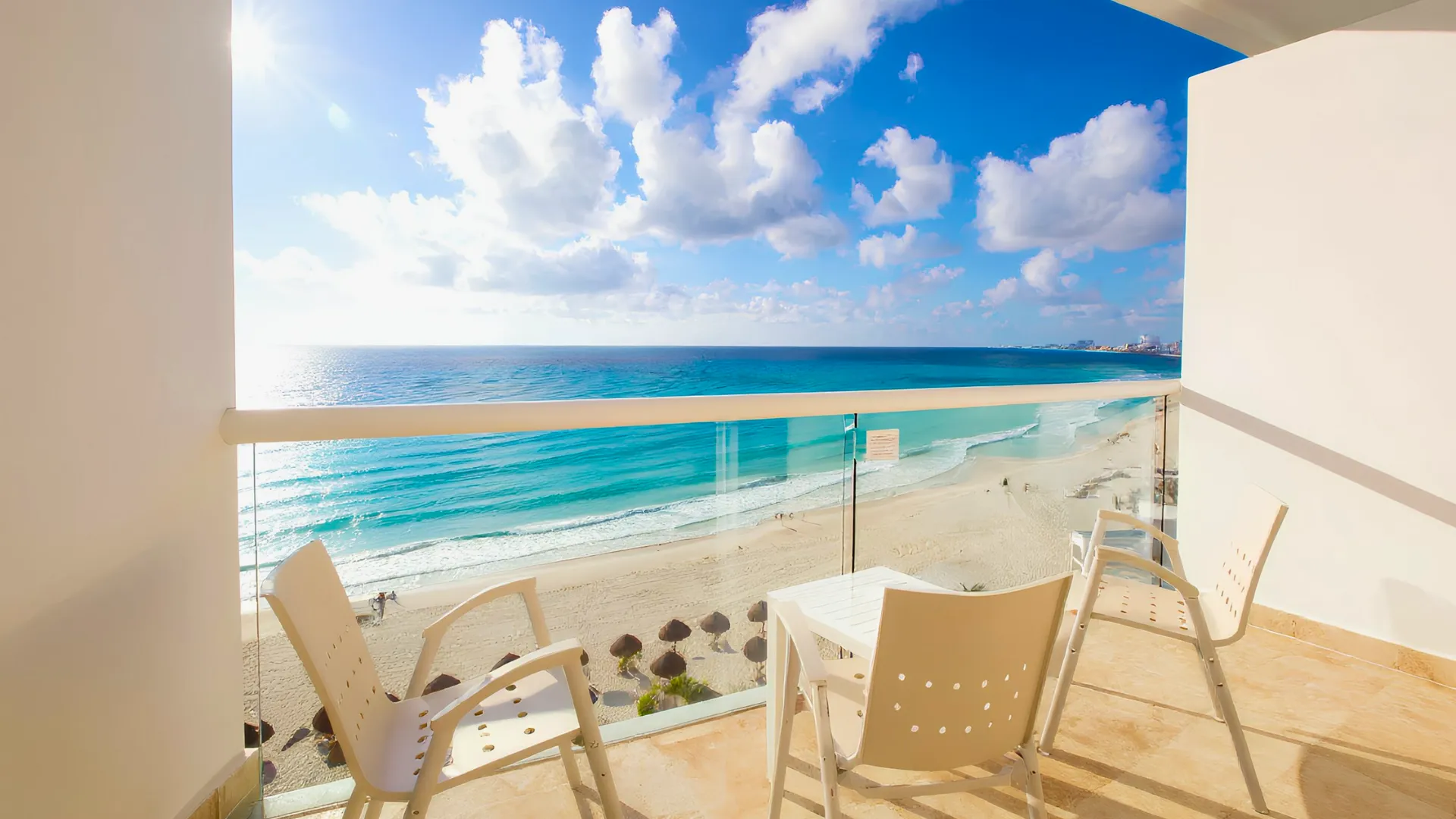 Ocean view from a balcony at Krystal Cancun, showcasing the beach and clear sky.
