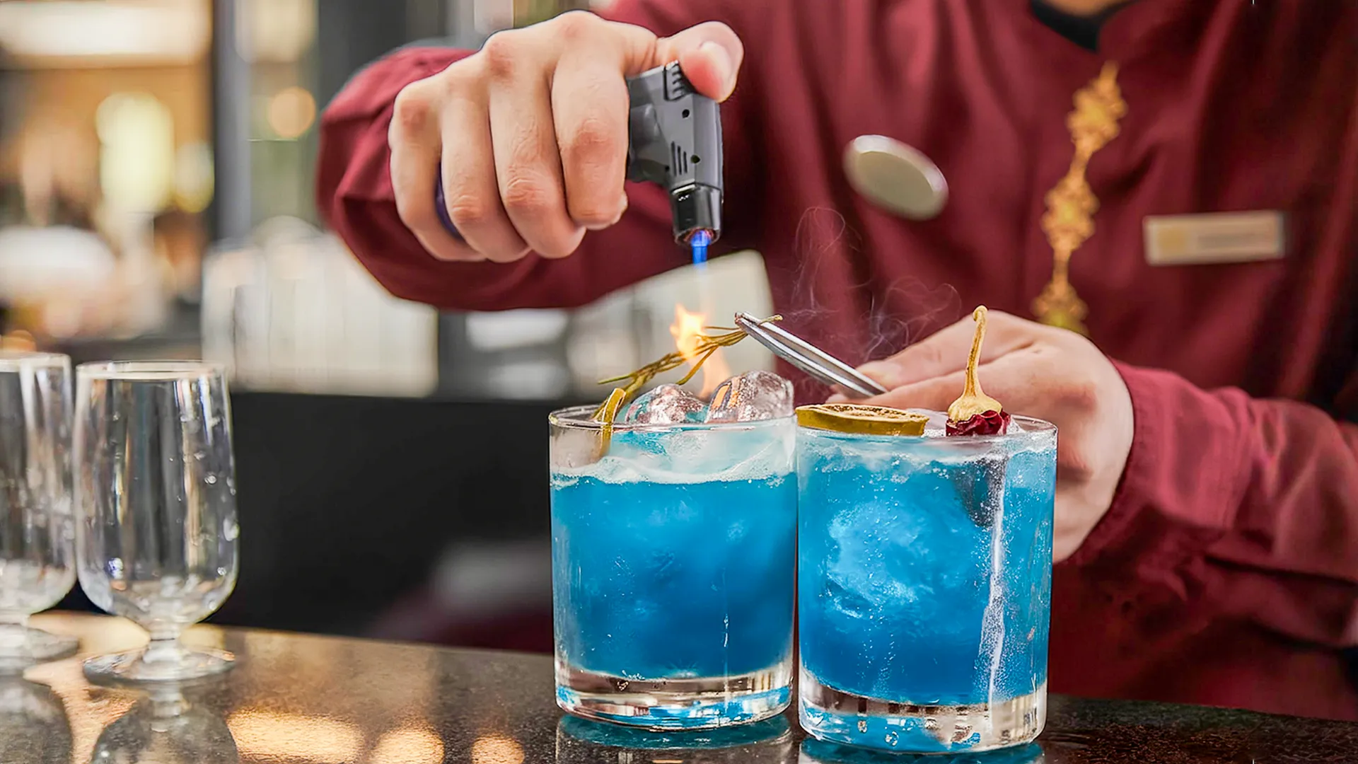  Bartender preparing blue tropical cocktails at Fiesta Americana Cancun resort bar.