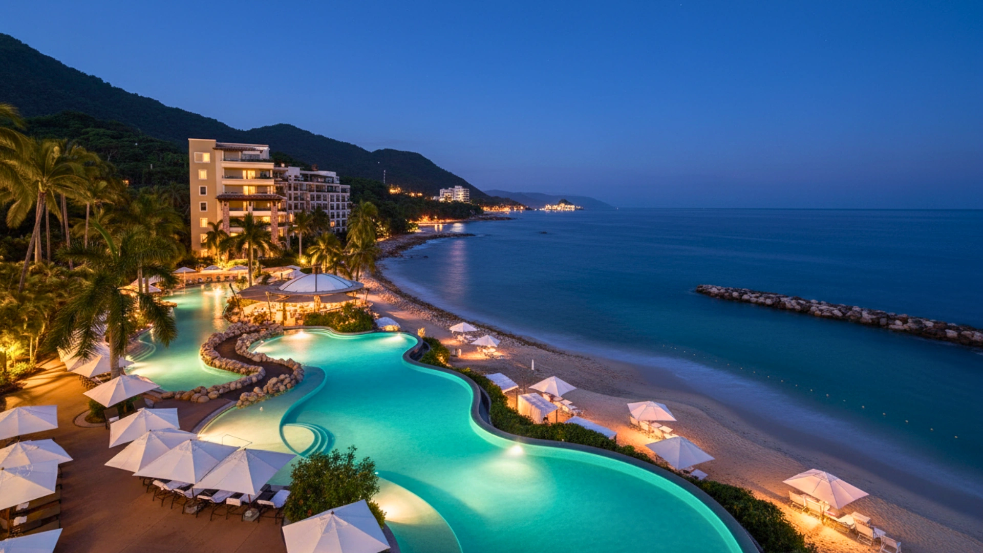 The Garza Blanca Cancun resort illuminated at night, with a view of the infinity pool and the beach beyond.
