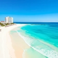 Panoramic view of Krystal Cancun resort, featuring pristine beach and crystal-clear blue waters.
