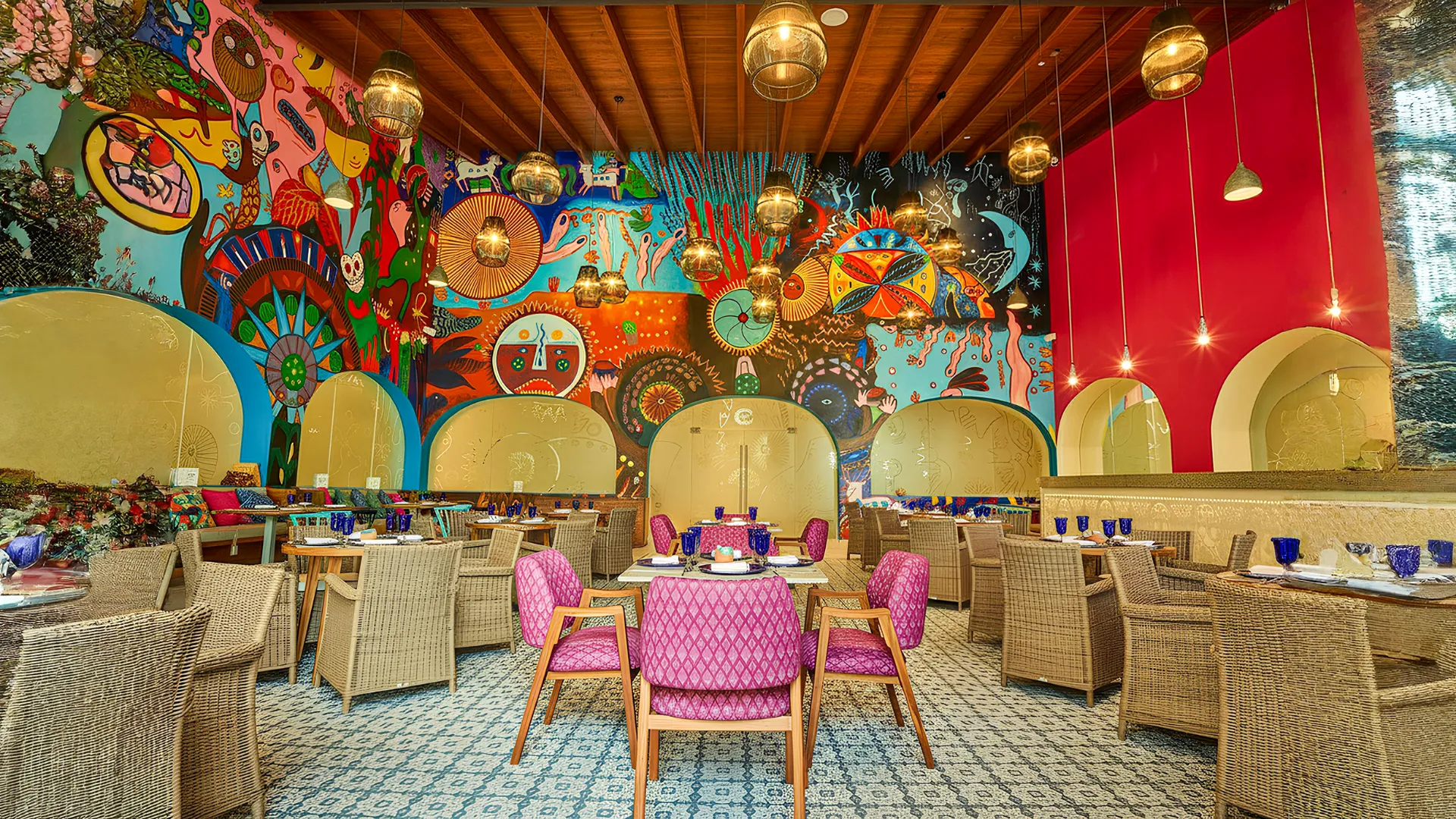  Colorful restaurant interior at Fiesta Americana Cancun featuring Mexican-inspired wall art and cozy dining tables.