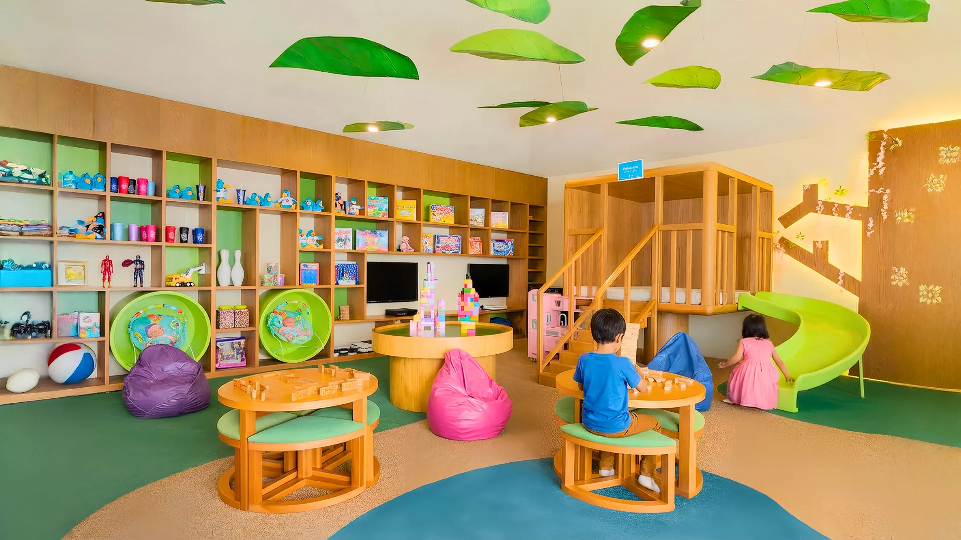 Colorful kids’ club at Royal Solaris Cancun with toys, games, beanbags, activity tables, and children playing.