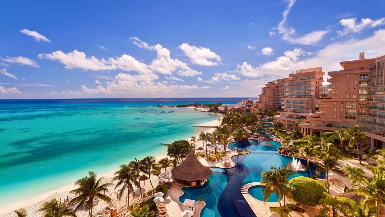 A stunning view of Fiesta Americana Cancun — where elegant beachfront pools meet the crystal-clear Caribbean waters.