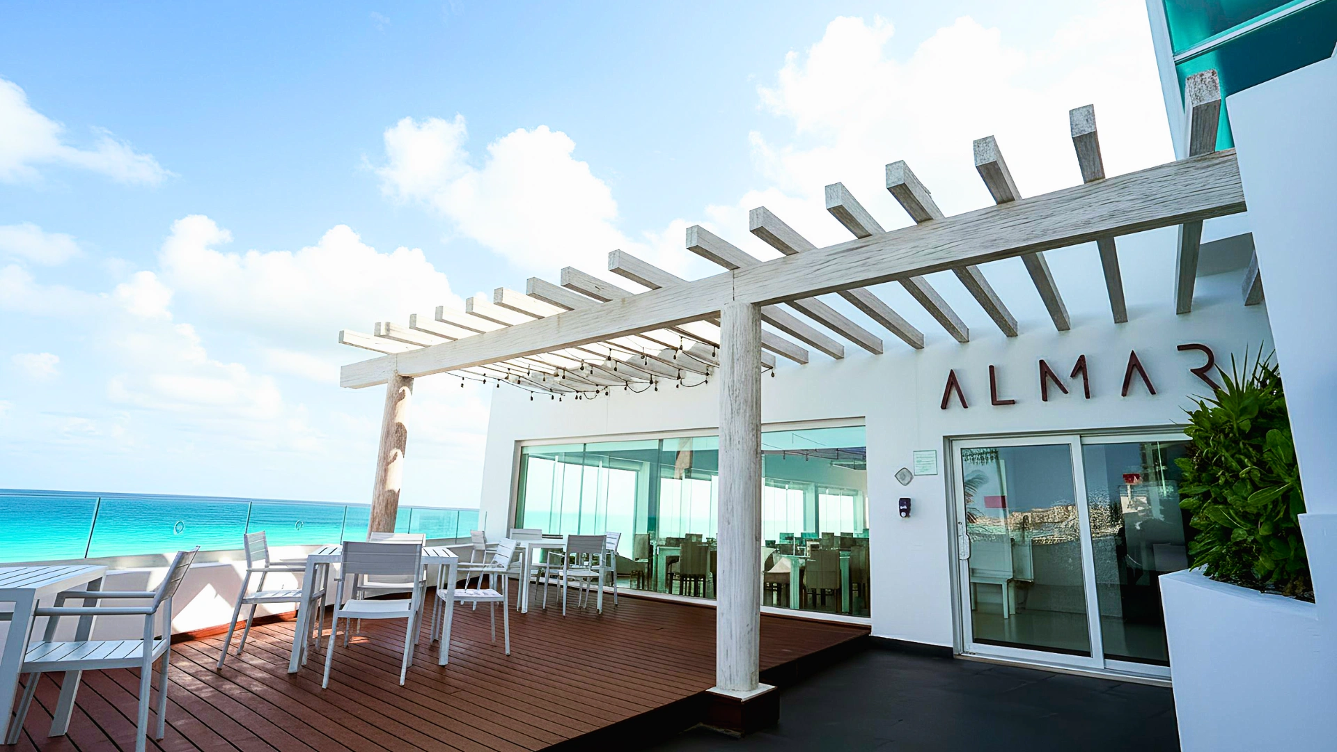 A beautiful outdoor dining area at the ALMAR resort in Cancun, with an ocean view and a relaxing atmosphere.