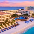 Aerial view of Marriott Cancun Resort at sunset, featuring beachfront pools, white sand, and turquoise Caribbean waters in Cancun’s Hotel Zone.