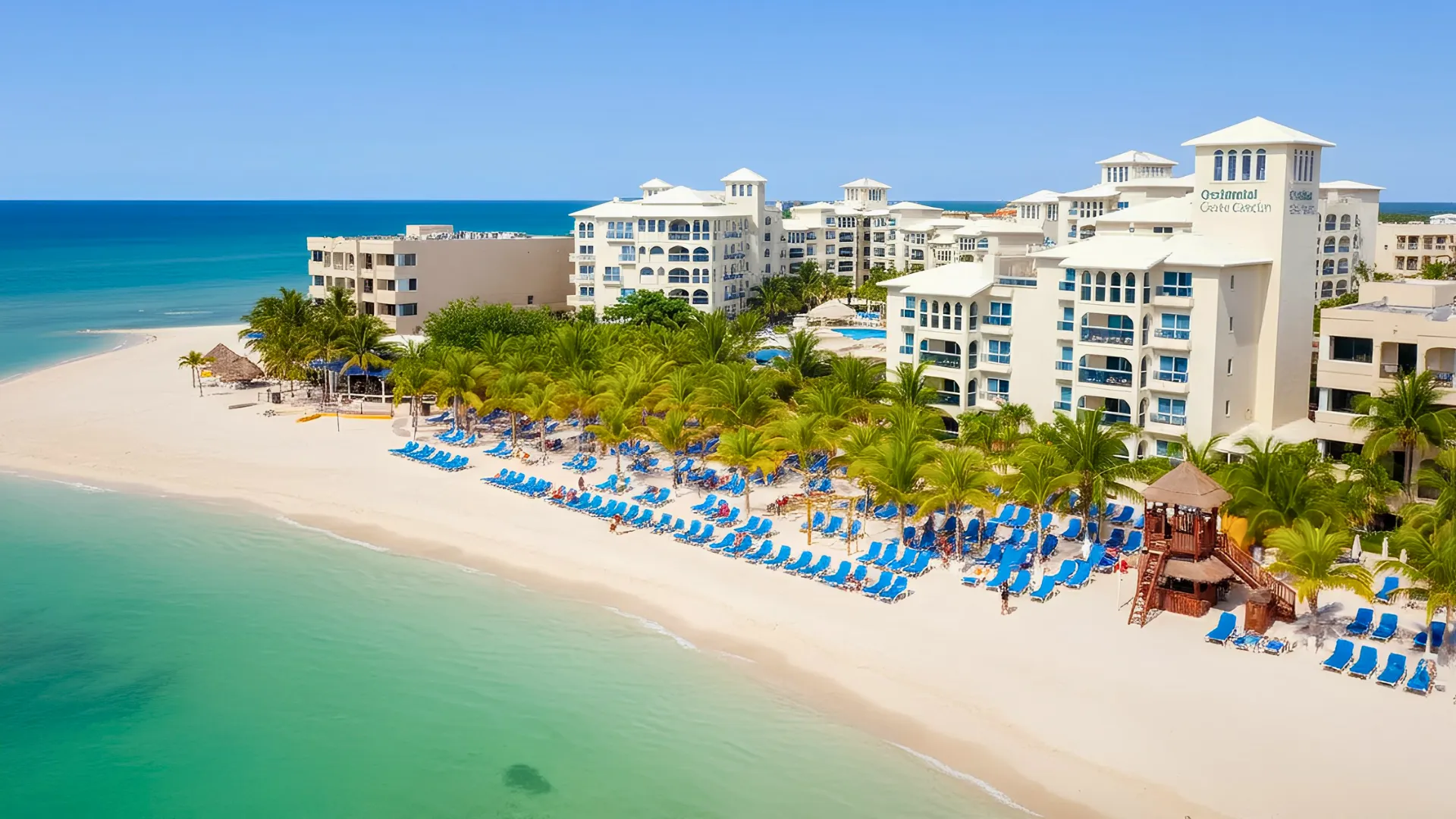 A beautiful beachside view of Occidental Costa Cancún with the resort buildings in the background.