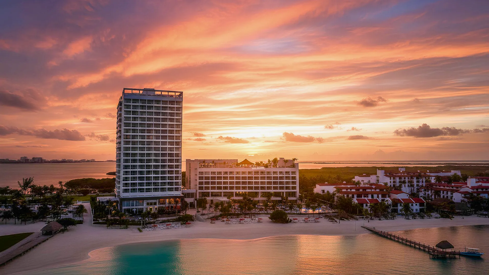 Club Med Cancun resort with a luxurious pool, palm trees, and spacious architecture, creating a tranquil tropical getaway.