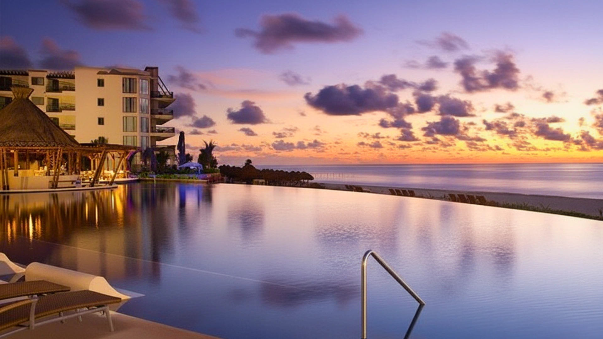Infinity pool at Dreams Riviera Cancun reflecting the sunset sky over the Caribbean Sea.