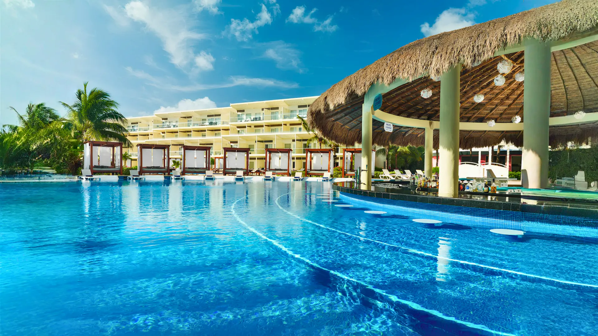 Main pool area with cabanas and a swim-up bar at Azul Beach Resort Riviera Cancun.