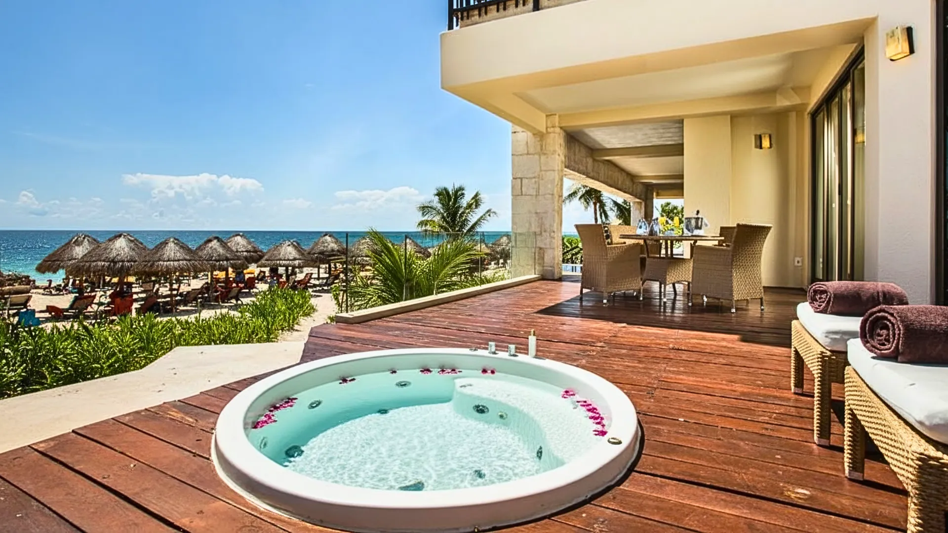 Preferred Club suite terrace at Dreams Riviera Cancun with private jacuzzi, sun loungers, and Caribbean Sea view.