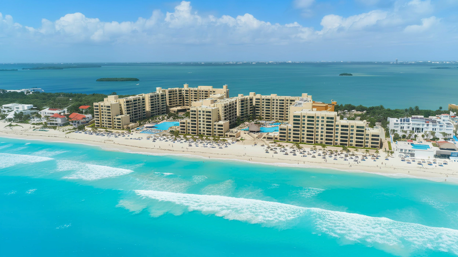 An aerial view of the beach with resorts and clear water at the Royal Sands Cancun.
