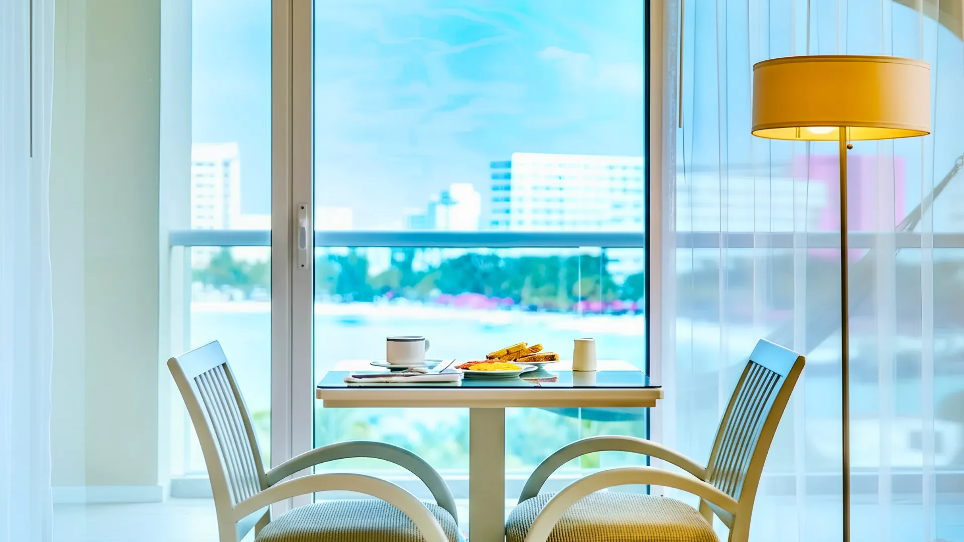 A well-lit hotel room with a breakfast setup on a table, showcasing the newly renovated room at Occidental Costa Cancún in 2025.