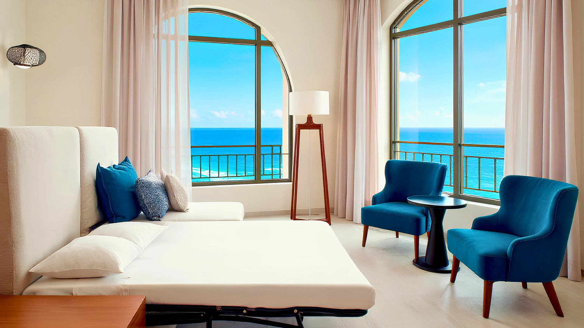 A luxurious ocean view room at JW Marriott Cancun, with plush bedding, modern furniture, and panoramic windows offering stunning sea views. 