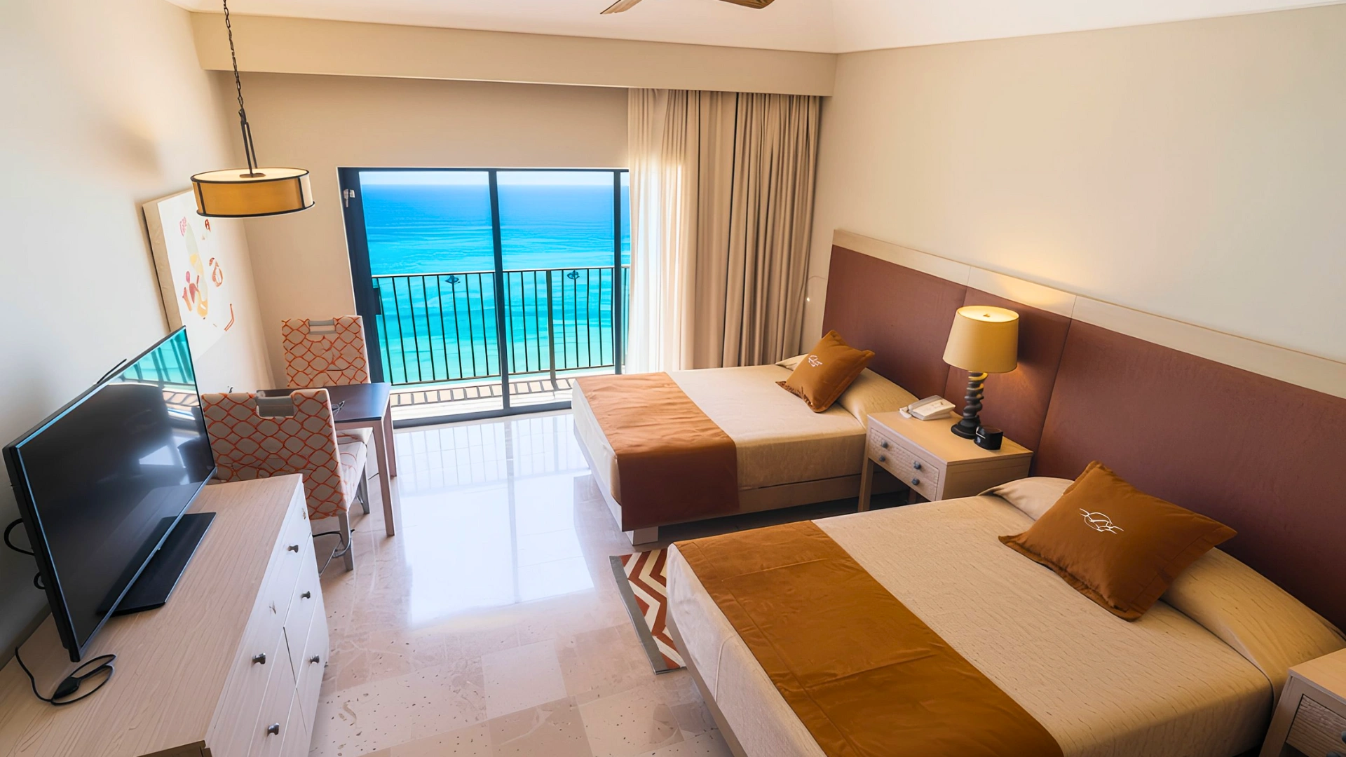 A hotel room at Royal Sands Cancun with a view of the ocean, featuring two beds and a bright, spacious atmosphere.
