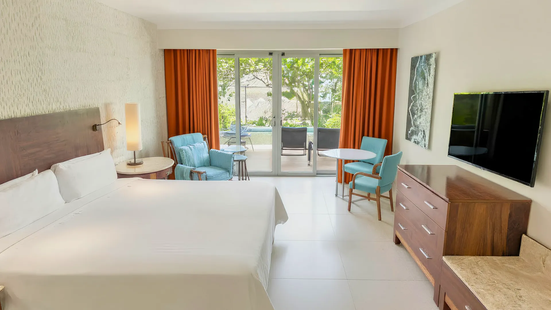 Bright and modern guest room at Fiesta Americana Cancun with king bed, seating area, and balcony view.