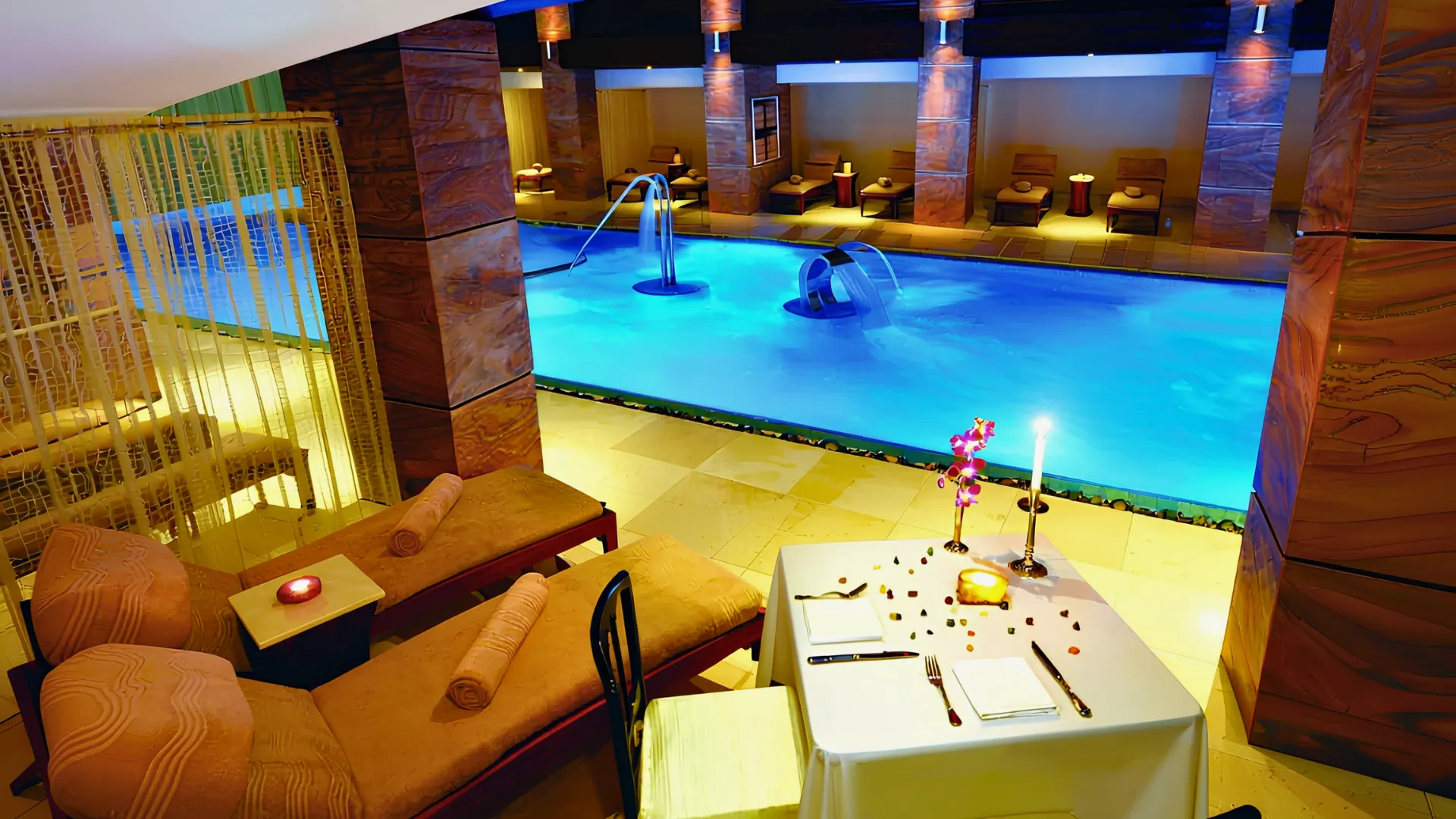 Gem Spa hydrotherapy pool at Grand Fiesta Americana Coral Beach Cancun with loungers, warm lighting, and romantic setup.