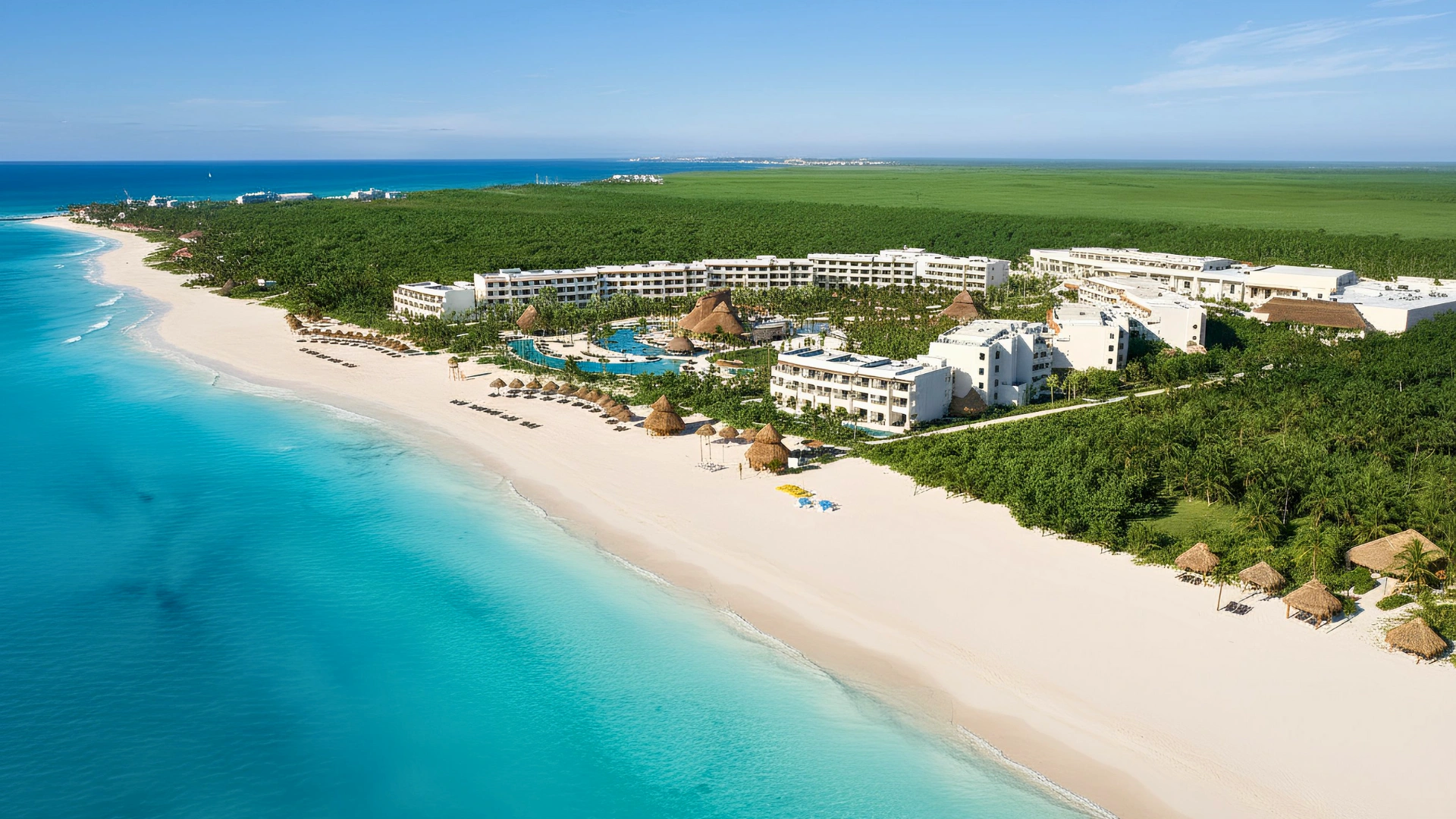 Aerial view of Cancun’s white-sand coastline and beachfront resorts along the Caribbean Sea.