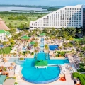 Aerial view of Iberostar Cancun resort with pyramid design, pools, and tropical gardens.