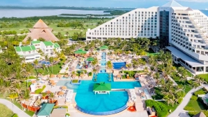 Aerial view of Iberostar Cancun resort with pyramid design, pools, and tropical gardens.