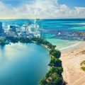 A creative split image showing Orlando’s city skyline merging into Cancun’s tropical beach, symbolizing travel from Florida to Mexico.